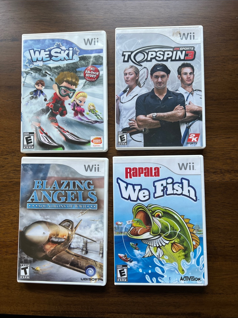 Lot of 4 Wii Games — We Ski, Top Spin 3, Blazing Angels, Rapala We Fish